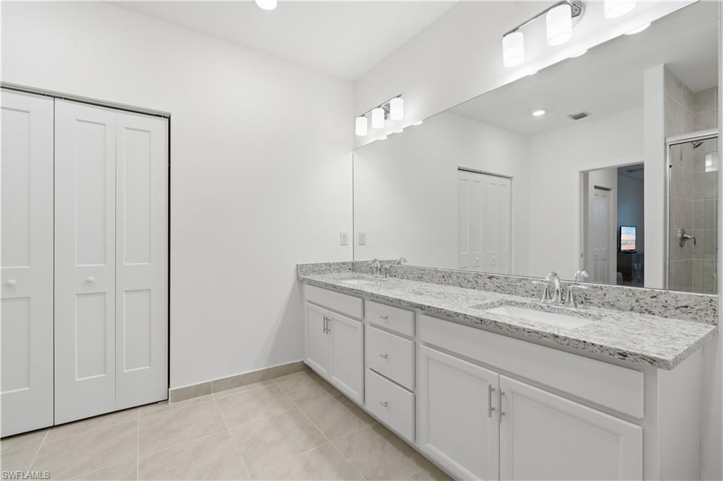 Primary bathroom with two separate sink areas, a walk-in shower and plenty of space for two!