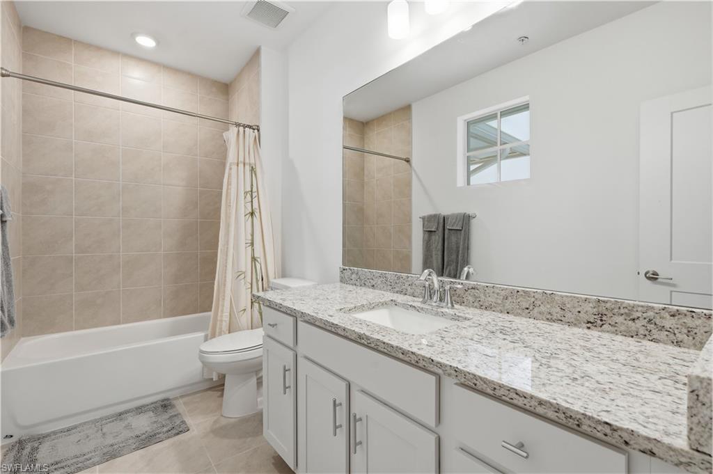 Second guest ensuite bathroom with shower/tub combo.