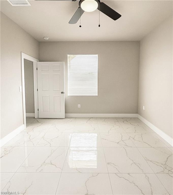 Spacious room featuring large format tile flooring, a ceiling fan with integrated lighting, window with blinds, and neutral wall tones