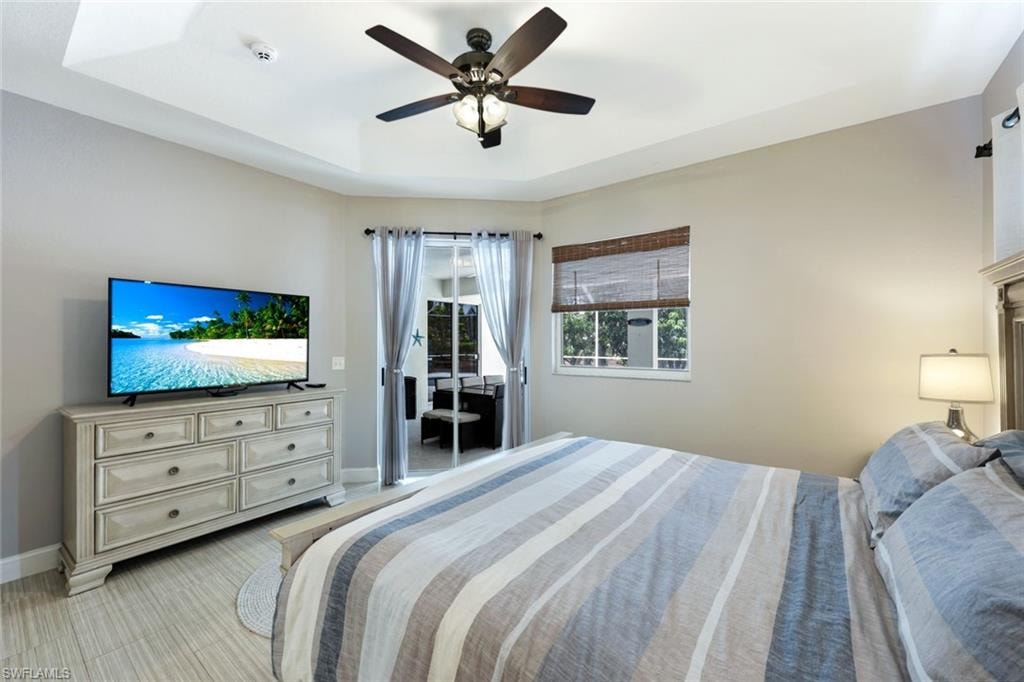 Bedroom with a tray ceiling and ceiling fan