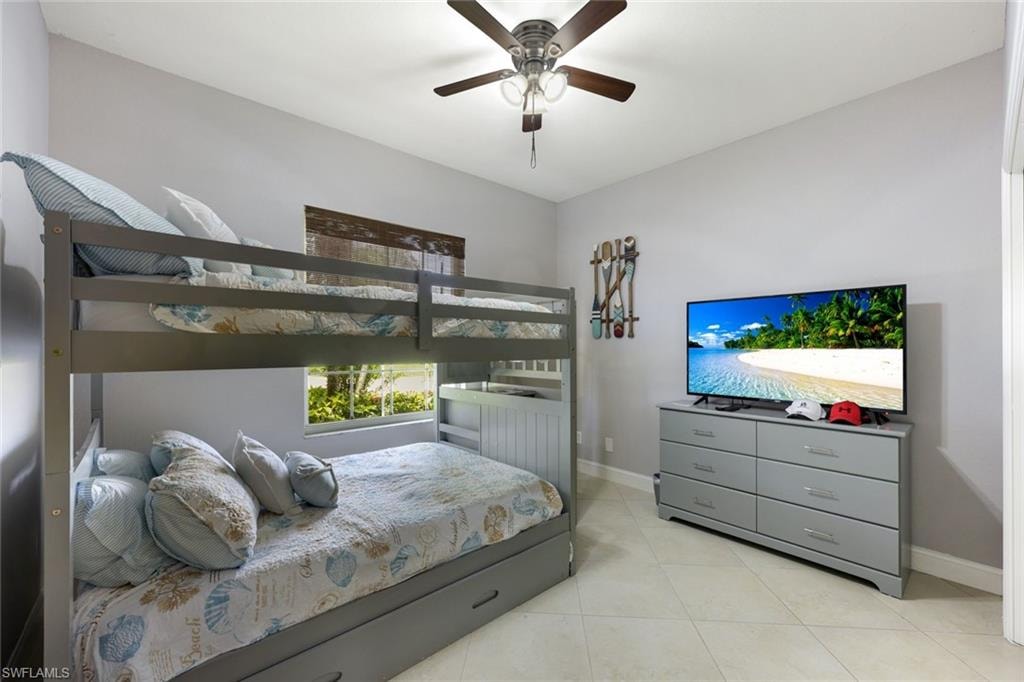Bedroom featuring light tile patterned flooring and a ceiling fan