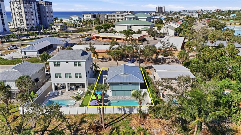 View of subject property featuring property boundaries highlighted and a large body of water- Virtually Edited Image