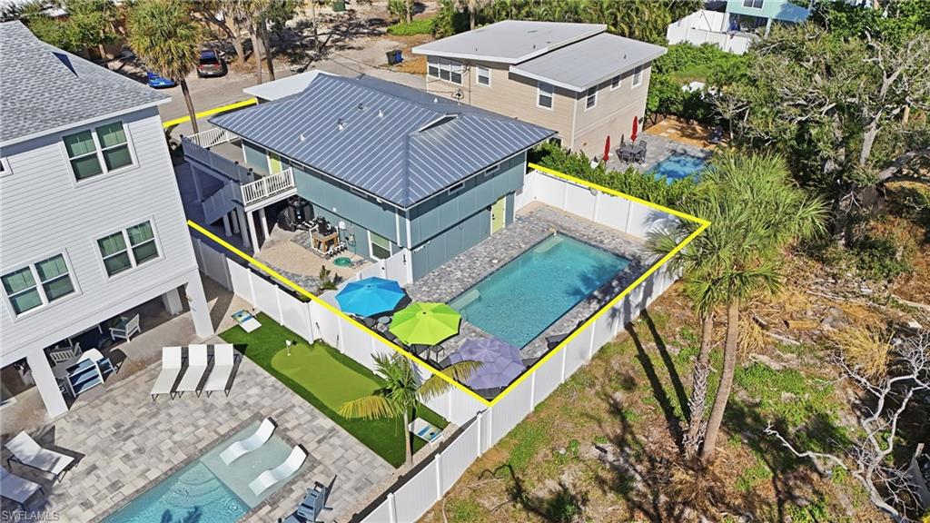 Aerial view of rear of house and pool featuring a pool area and property boundaries highlighted- Virtually Edited Image