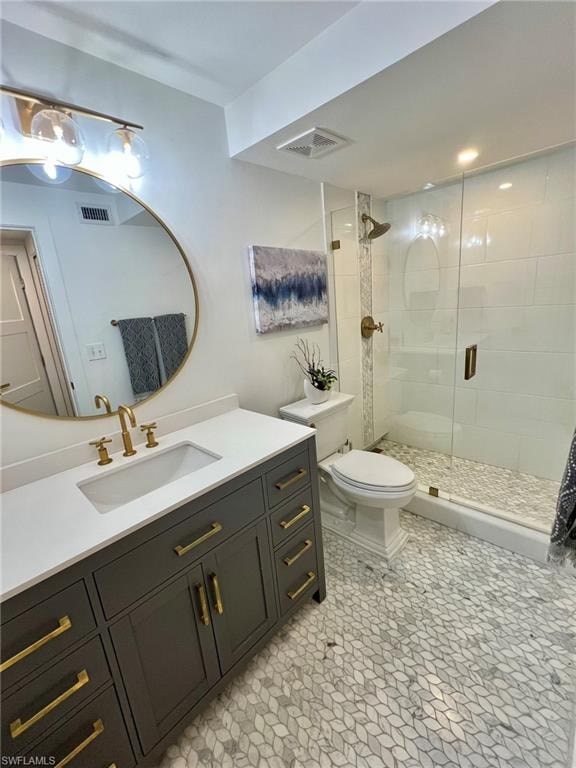 Bathroom featuring a dark gray vanity with gold hardware and a white countertop