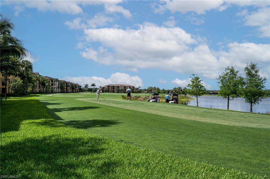 Expansive golf course with manicured greens and a water feature