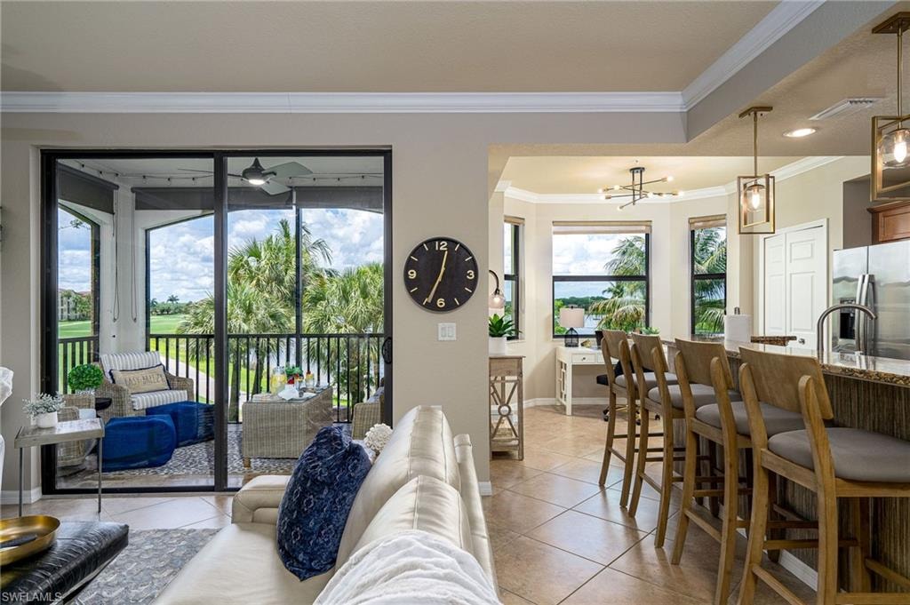 Expansive screened lanai with tropical foliage and golf course scenery