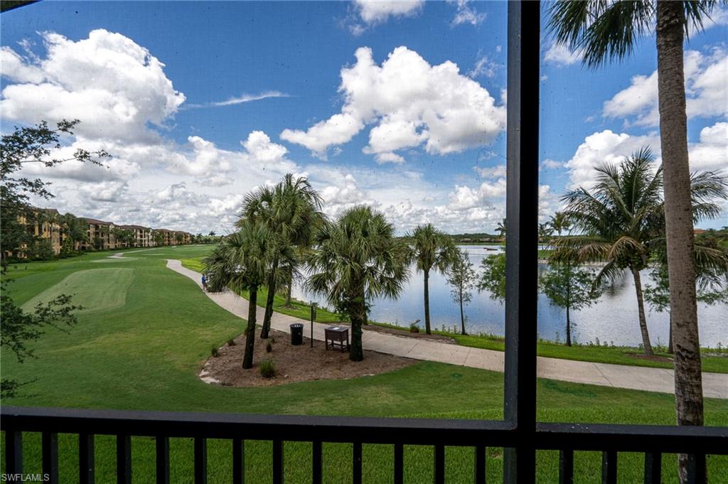View of golf course fairway and lake from private screened lanai