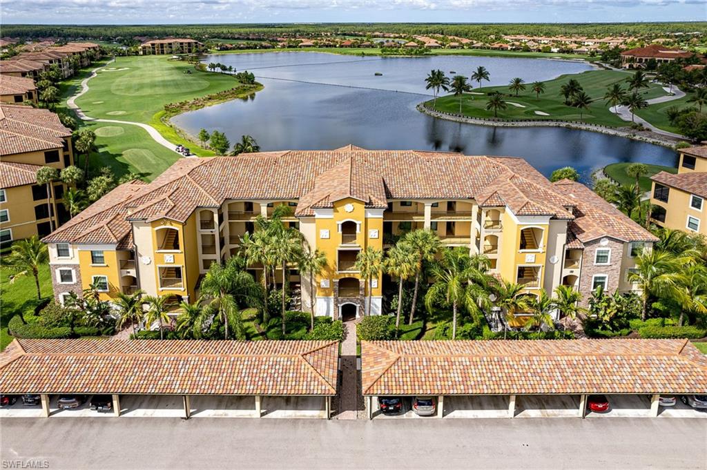 Multi-story residential building featuring Mediterranean-inspired architecture with tile roofing, stucco exterior, and balconies