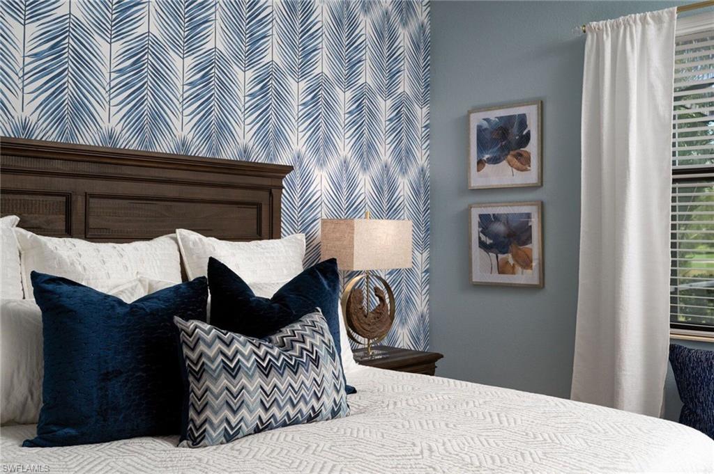 Accent wall featuring blue palm frond pattern wallpaper