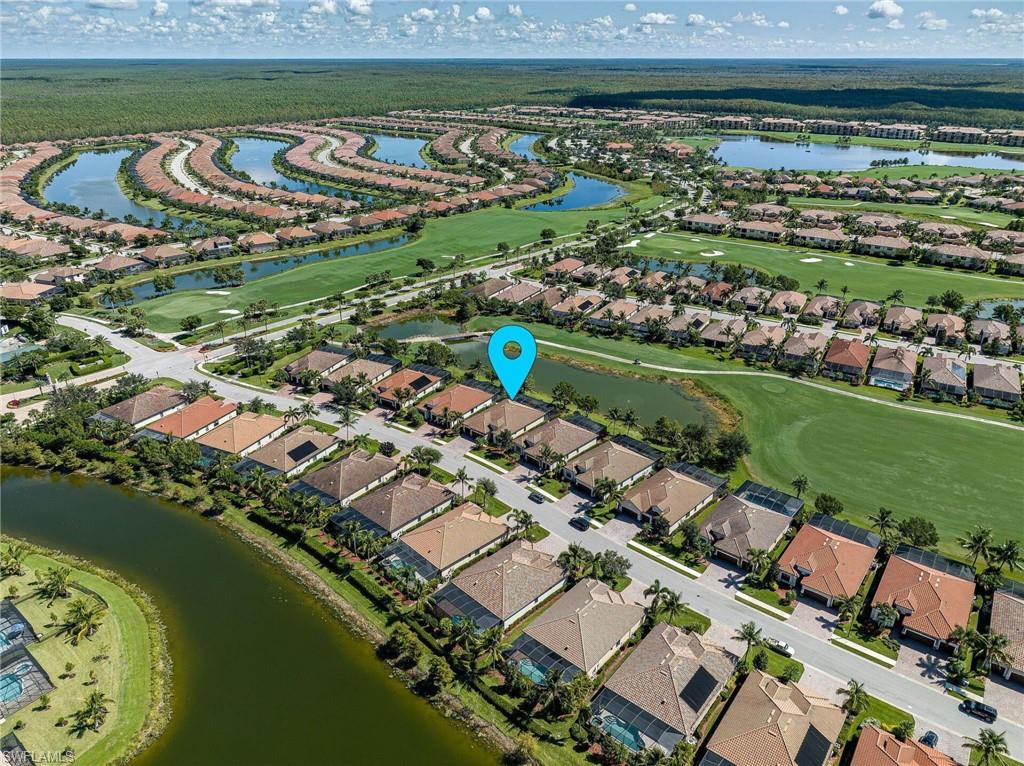 Aerial overview of a residential community featuring numerous homes with screened lanais and private pools
