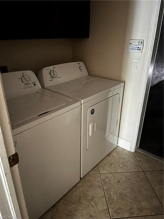 Dedicated laundry area featuring a white top-load washing machine and a white front-load dryer