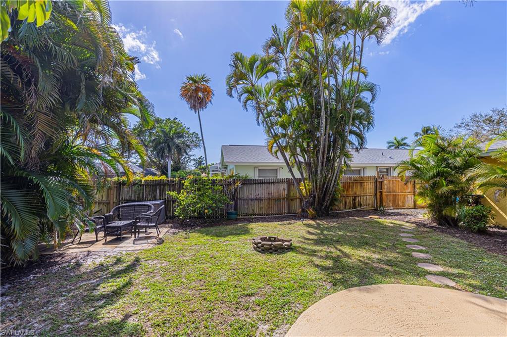 View of yard with a fire pit and fenced yard