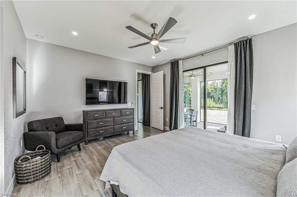 Light-toned wood-finish flooring extending throughout, recessed lighting, and a modern ceiling fan with integrated lighting