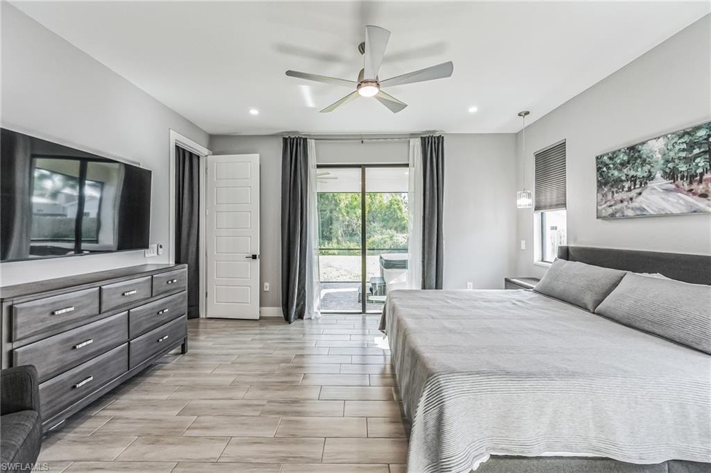 Spacious room featuring light wood-finish plank flooring and recessed lighting