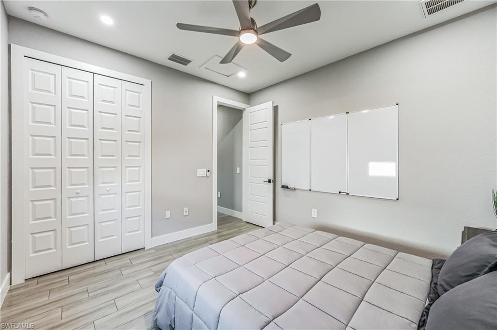 Interior room featuring wood-finish flooring, recessed lighting, and a ceiling fan