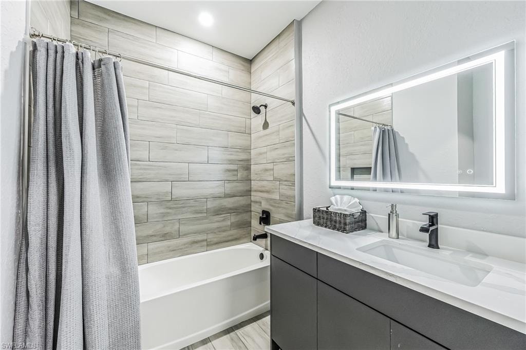 Contemporary bathroom featuring a tub and shower combination with wood-look tile surround