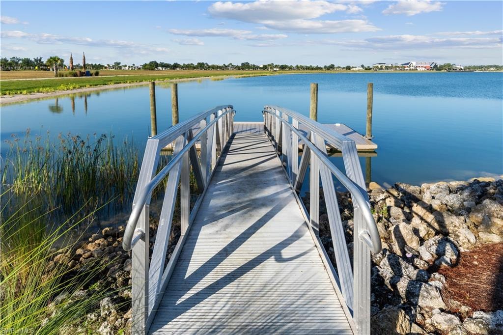 Aluminum dock ramp extending to a floating platform with two wooden pilings