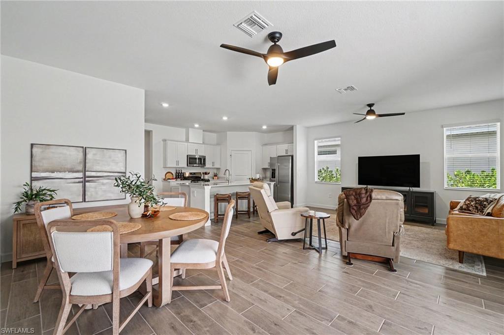 Open-concept interior featuring wood-finish flooring, recessed lighting, and ceiling fans