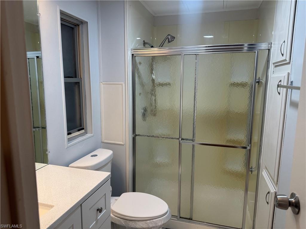 Shower stall with sliding frosted glass doors and chrome hardware