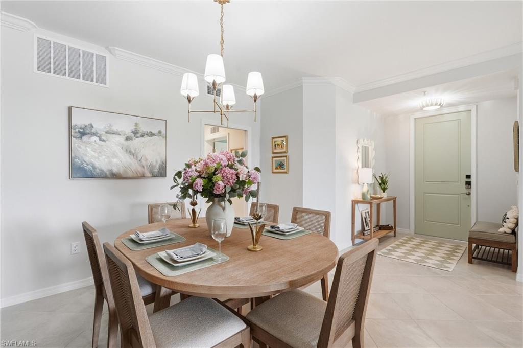 Dining area featuring a contemporary chandelier, crown molding, and light-toned flooring
