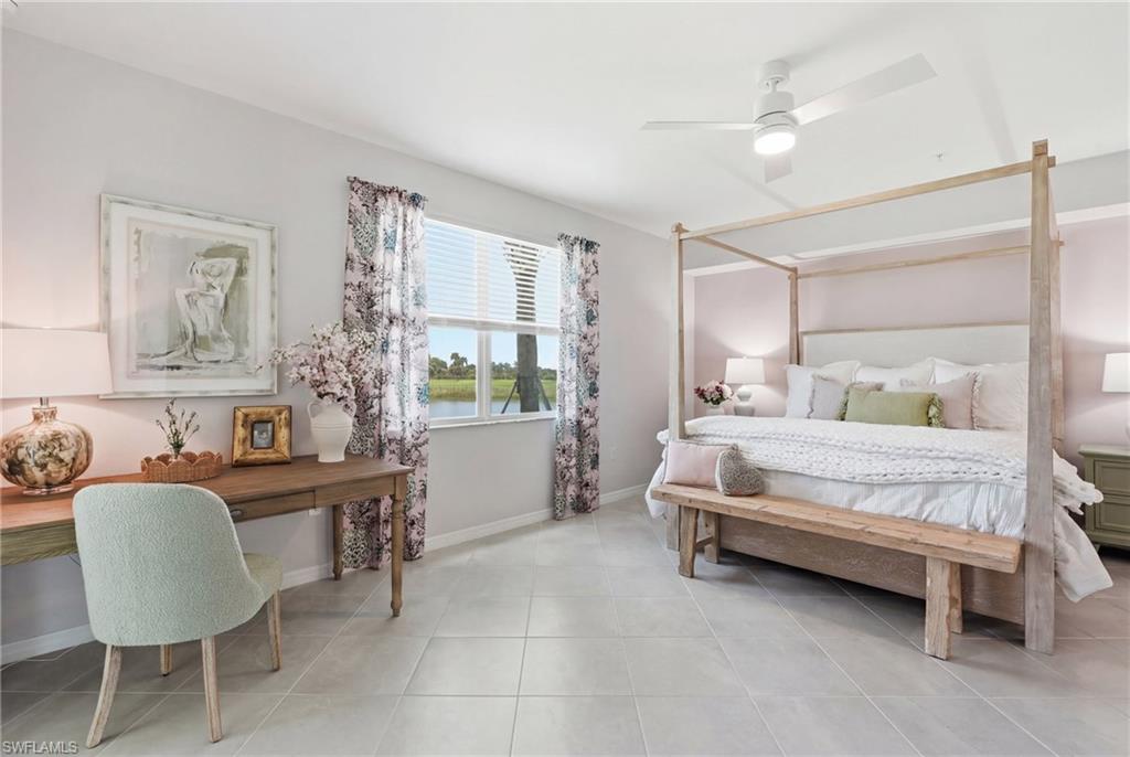 Spacious room featuring tile flooring, a large window with blinds, and a ceiling fan with integrated lighting