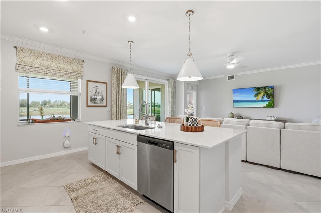 Spacious kitchen island with an undermount sink and stainless steel dishwasher