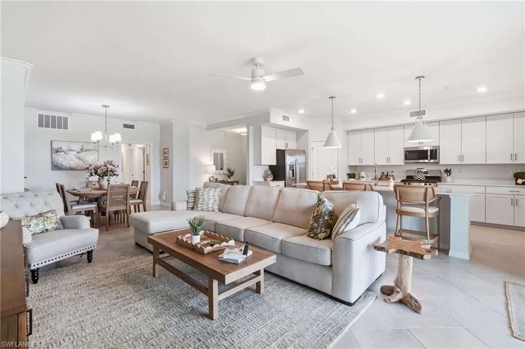 Open-concept living area featuring light-toned flooring, a ceiling fan, and recessed lighting
