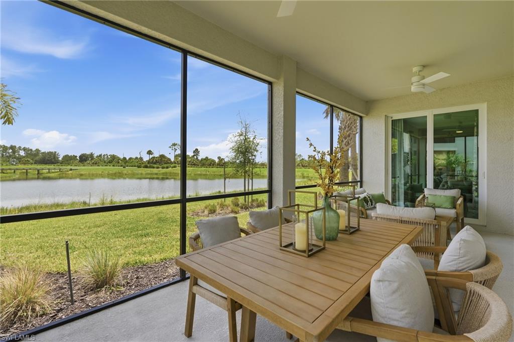 Screened lanai featuring a concrete floor, ceiling fan, and sliding glass doors
