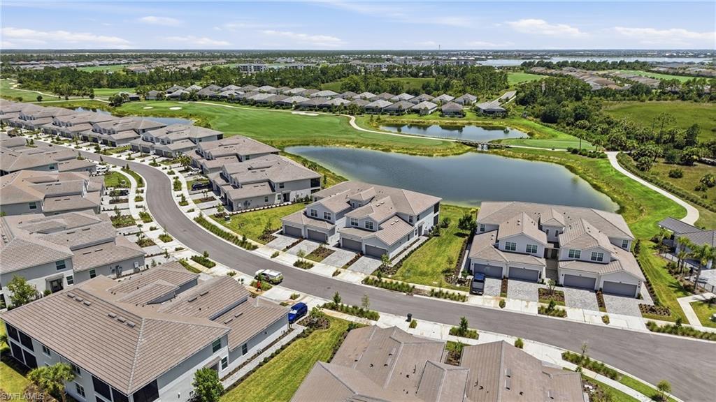 Aerial perspective showcasing a residential community with manicured landscaping and water features
