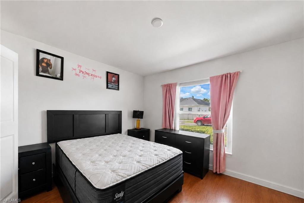 Bedroom featuring wood-finish flooring and a bright window