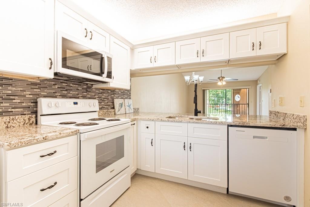Kitchen featuring white shaker-style cabinetry, granite-finish countertops, and a full suite of appliances