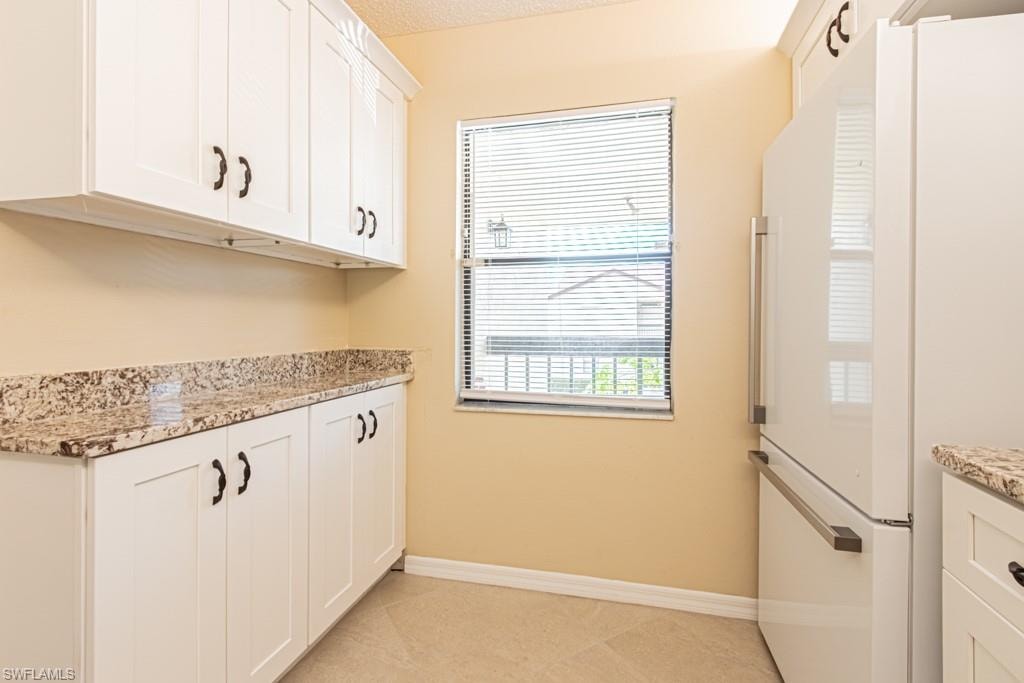 White shaker-style cabinetry with soft close drawers and natural light