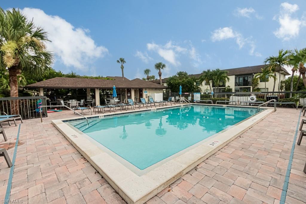 Rectangular swimming pool with integrated steps, surrounded by brick paver decking