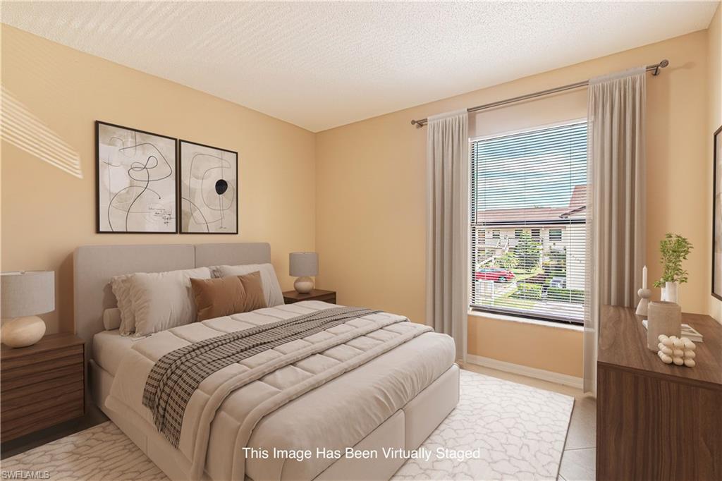 Spacious guest room with large walk in closet and tiled flooring