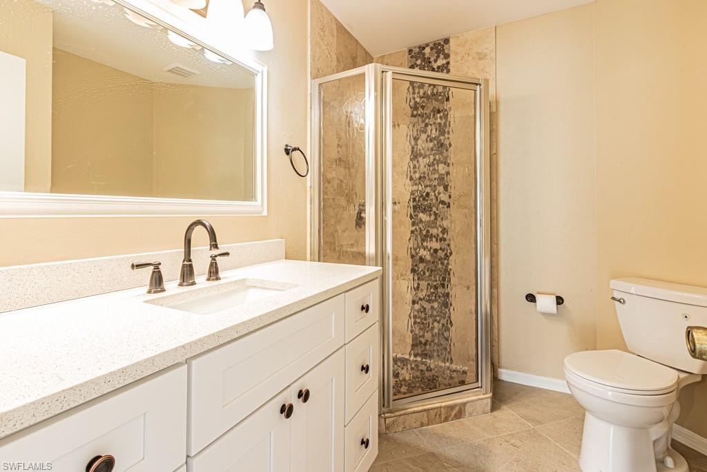 Luxurious Quartz Vanity countertop. Updated cabinerty. Walk in shower with ornate pattern.  Newly tiled