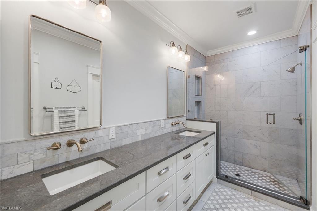 Gorgeous updated master bath with dual vanity with integrated sinks, quartz counters, and wall-mounted faucets