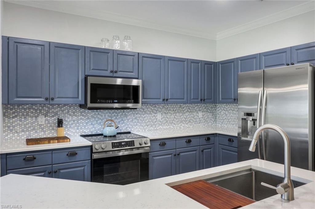 Beautifully updated kitchen with stainless steel appliances, counter height quartz counter tops & hexagon marble tiled backsplash.