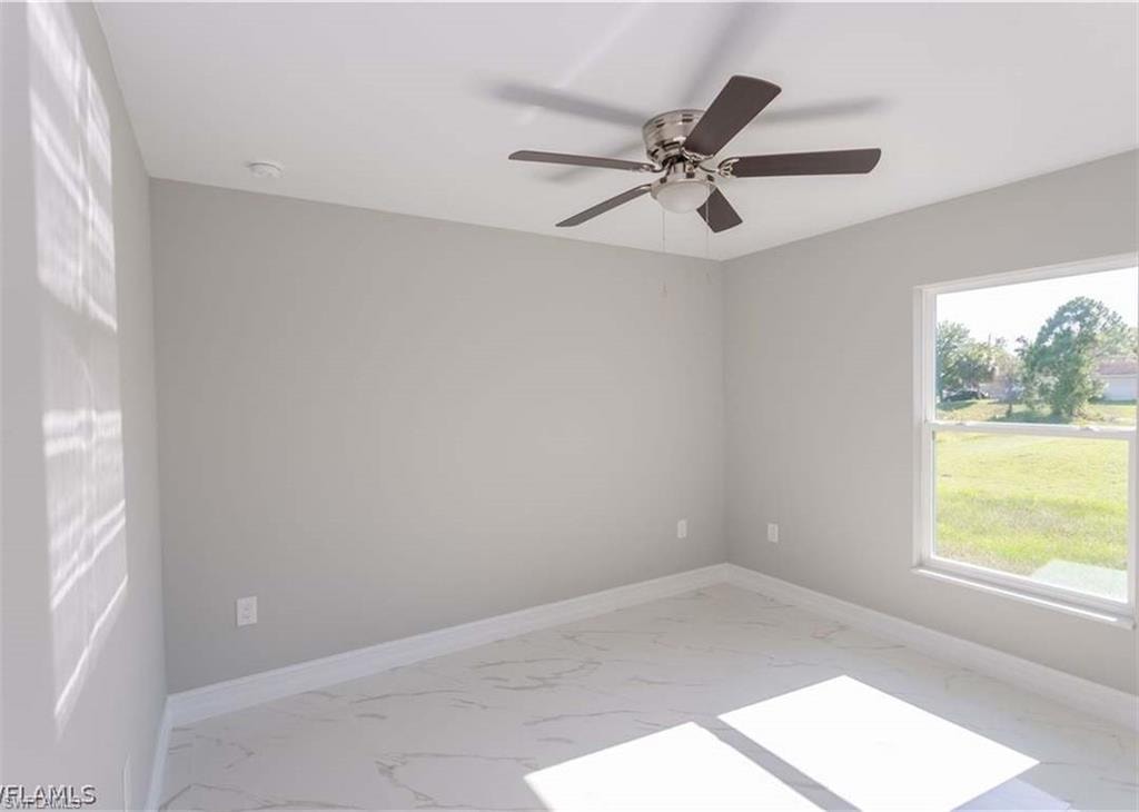 Interior room featuring light gray walls and white baseboards