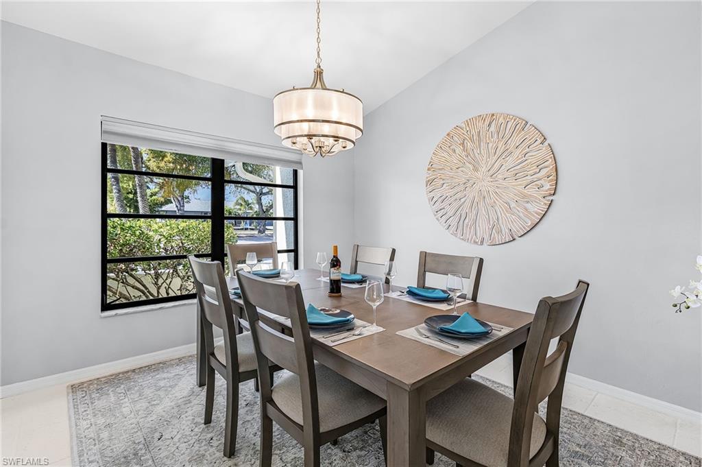 Dining room with vaulted ceiling and a chandelier