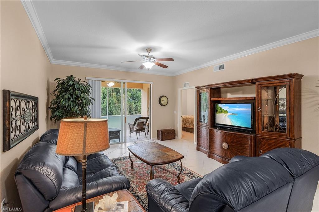 Living area featuring crown molding, neutral wall tones, and tile flooring