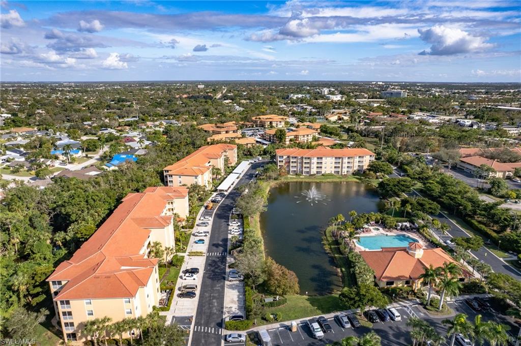 Aerial perspective showcasing a community with multiple residential buildings featuring terracotta-style roofing