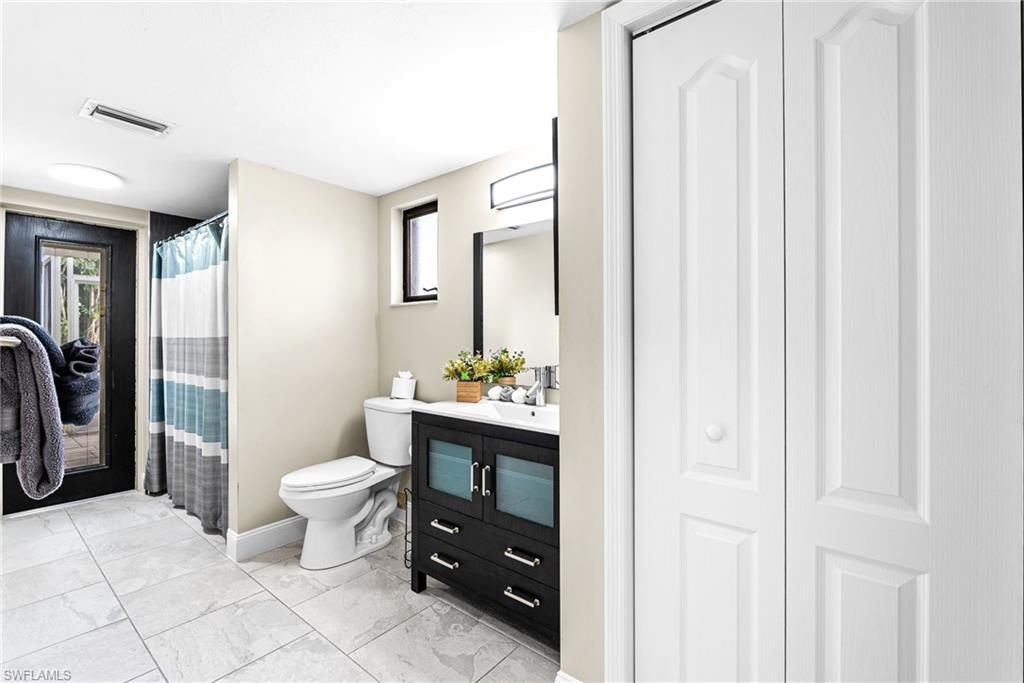 Full bath with vanity, a closet, and a shower with curtain