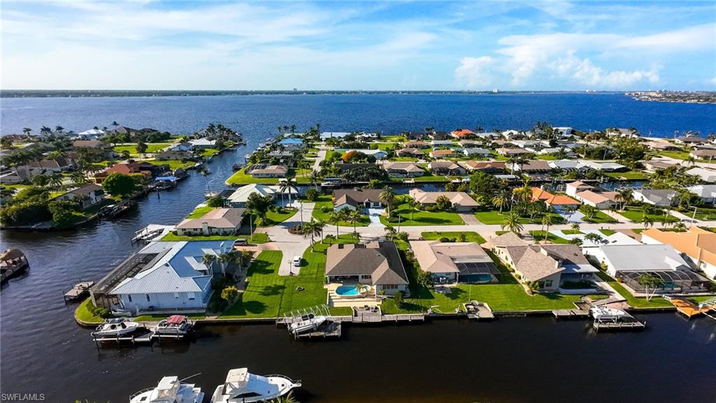 Aerial view of residential area featuring a large body of water
