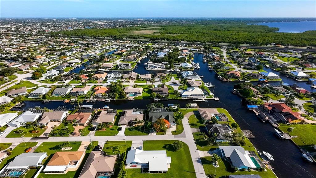 Aerial view of property's location featuring a large body of water and nearby suburban area