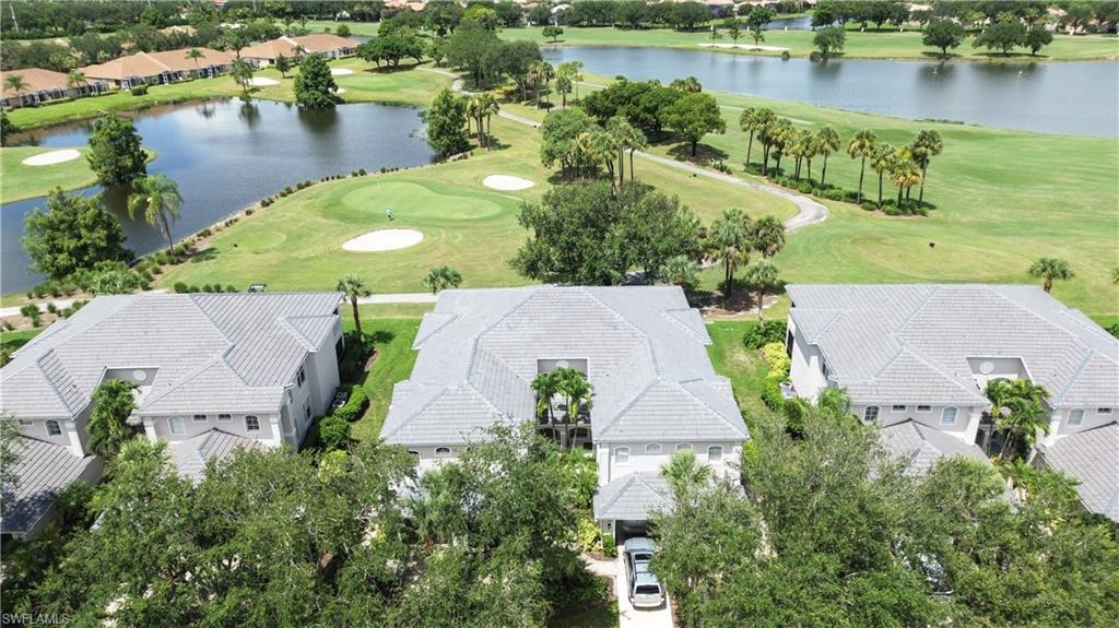 Aerial perspective of suburban area featuring a golf club and a large body of water