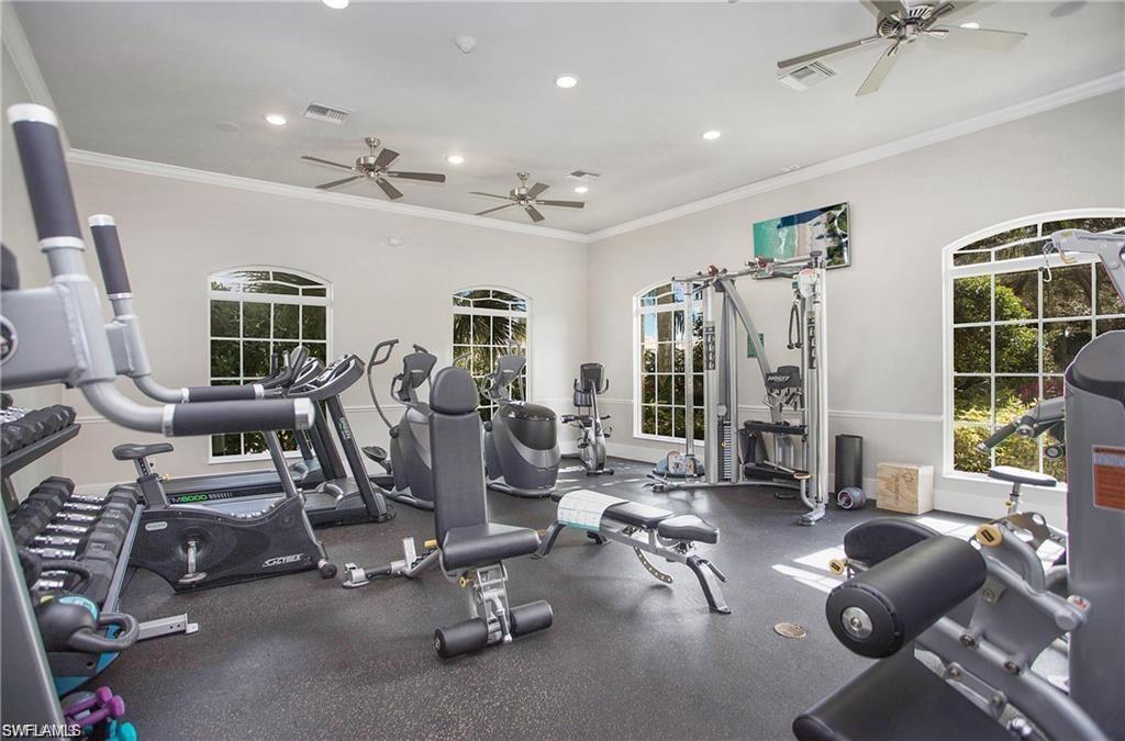 Workout area with ceiling fan, recessed lighting, and ornamental molding