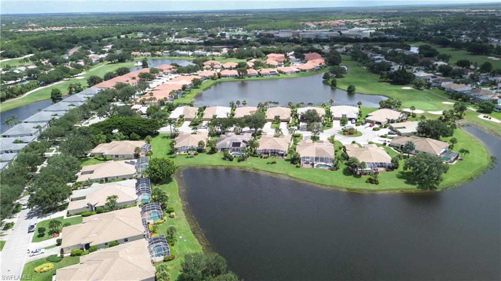 View of property location featuring nearby suburban area, a nearby body of water, and a golf course