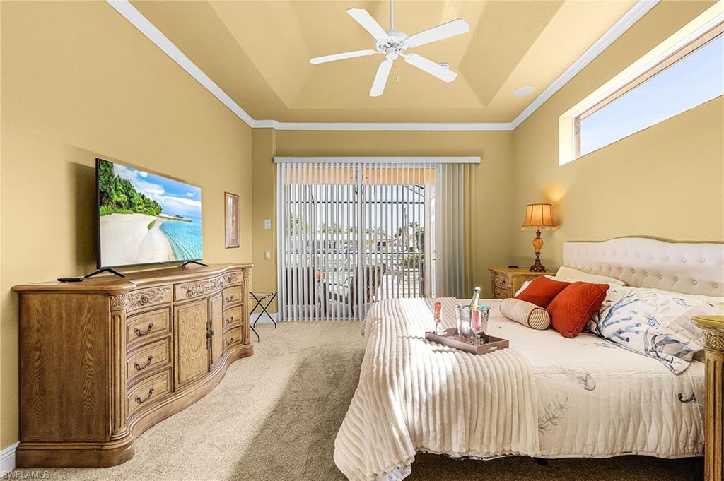 Primary Bedroom with King size bed, flatscreen tv and slider to the pool area