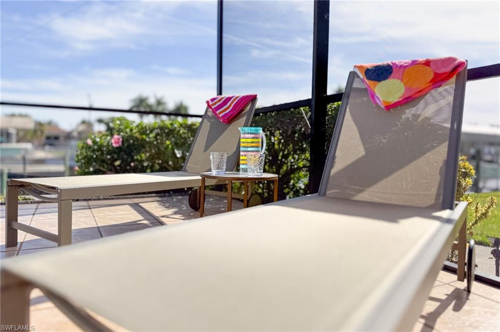 View of pool patio w/ loungers