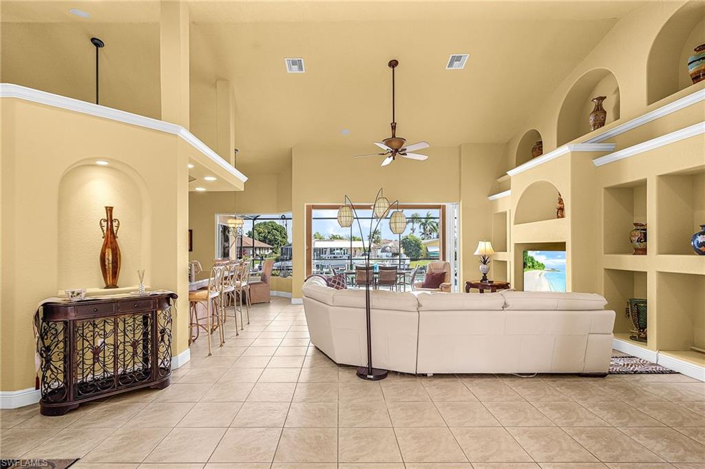 Living area featuring built in shelves and vaulted ceilings